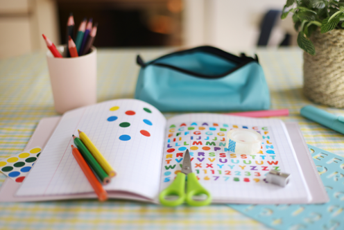 Open school supplies show a child preparing, learning and creating—making the return to school feel active and manageable.